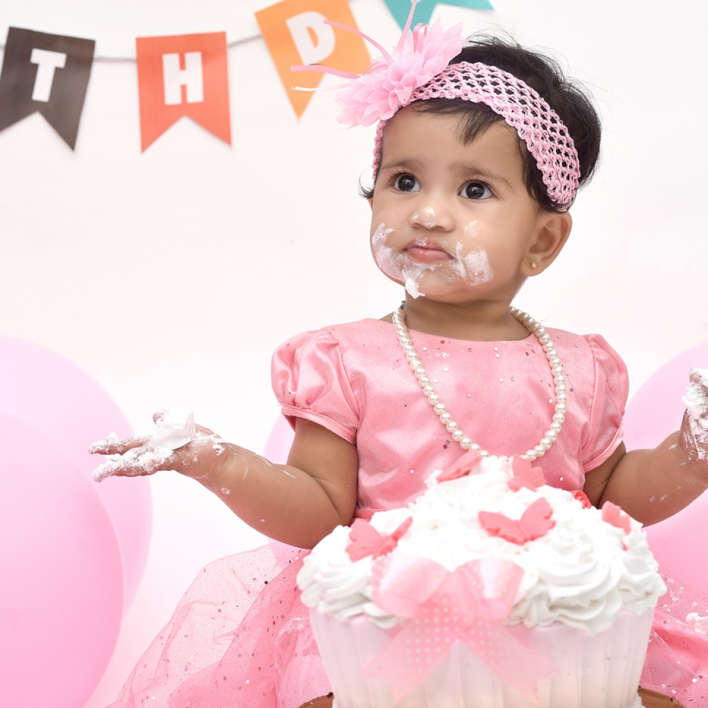 Baby girl covered with smash cake