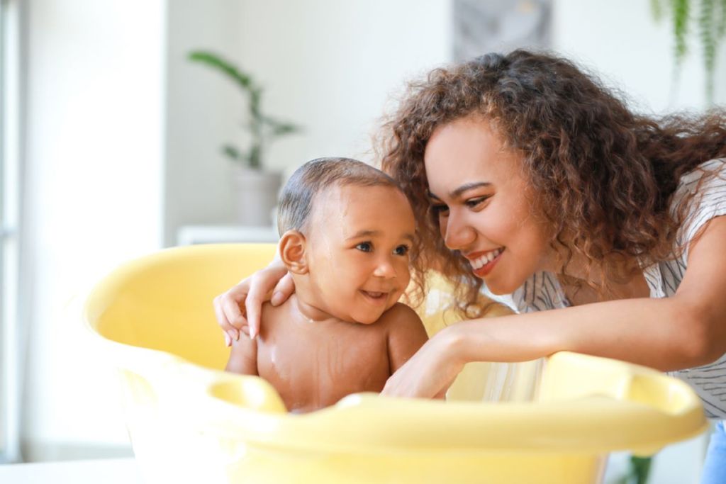 A parent giving a baby a bath