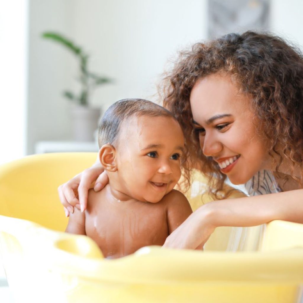 A parent giving a baby a bath