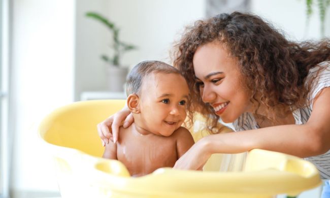 A parent giving a baby a bath