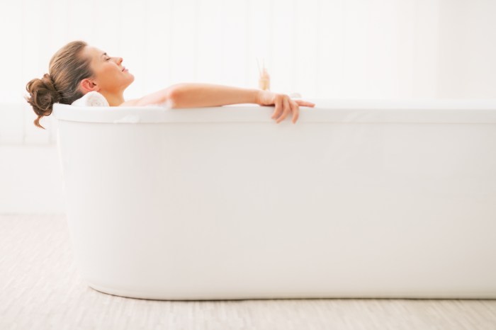 A new mom relaxes in the bathtub