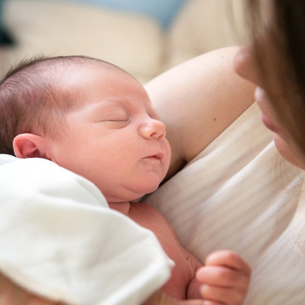Mother holding sleeping baby