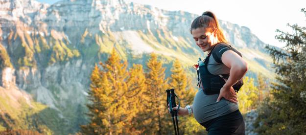 Pregnant woman hiking on a trail