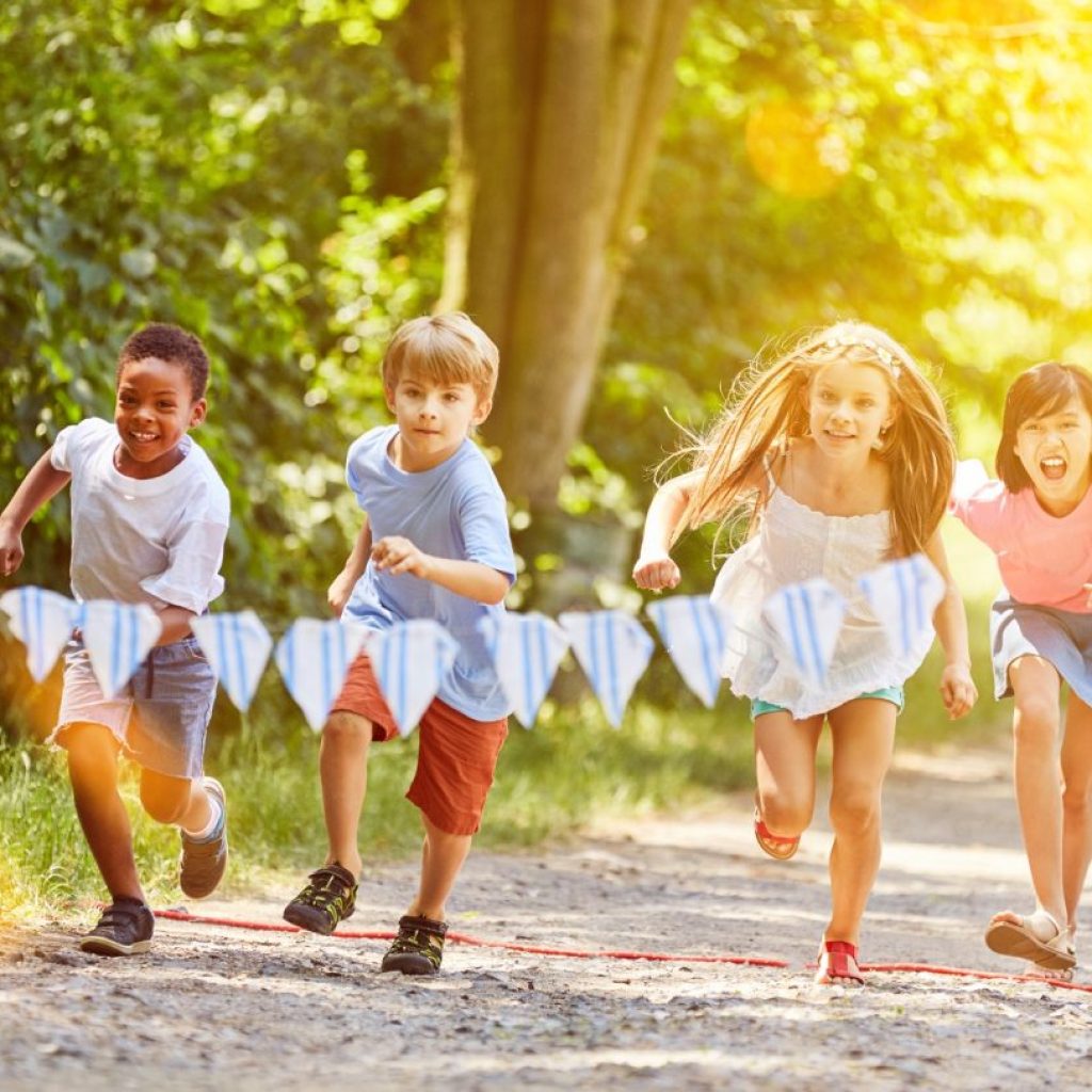 Kids running with each other at a party.