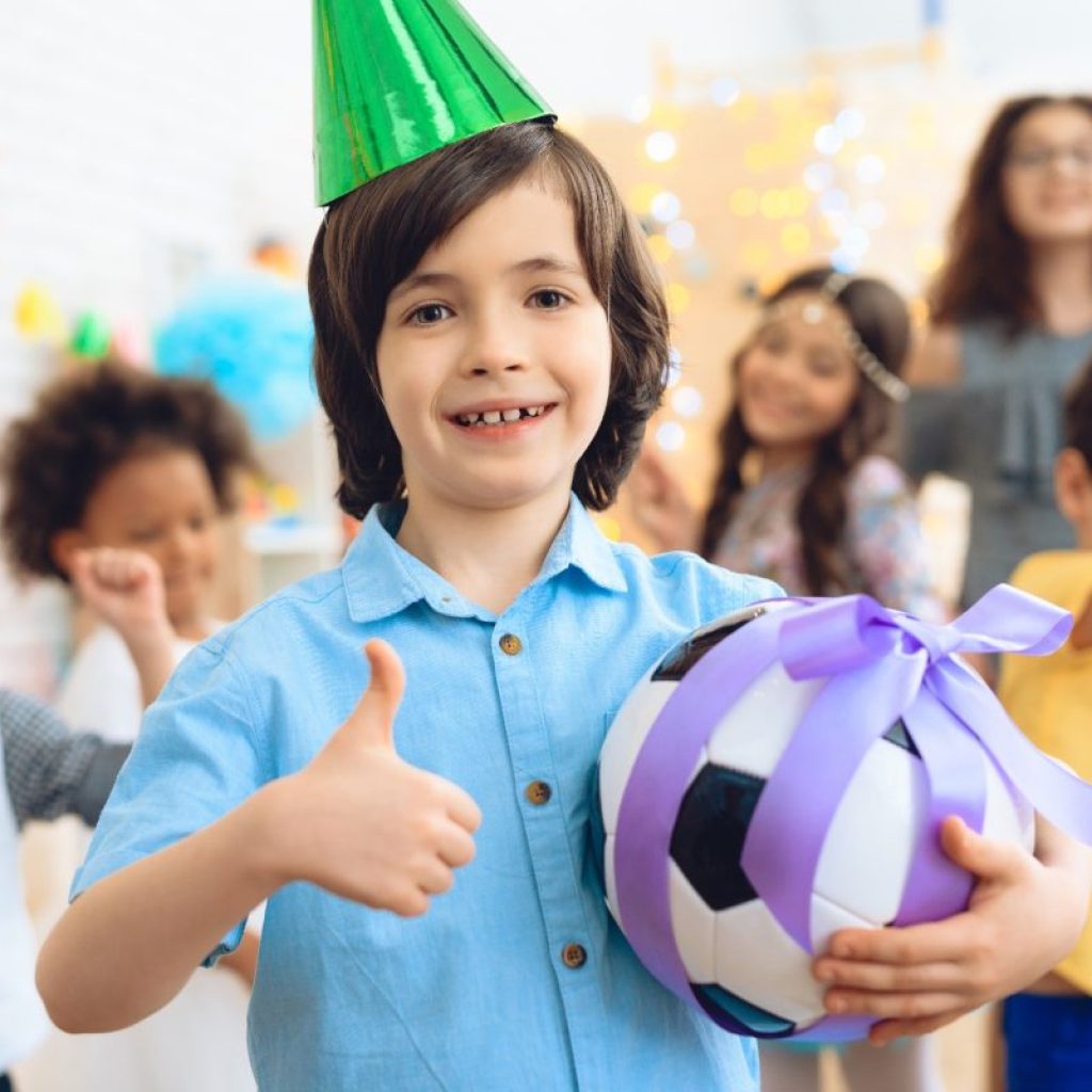 A child getting a soccer ball for their birthday.
