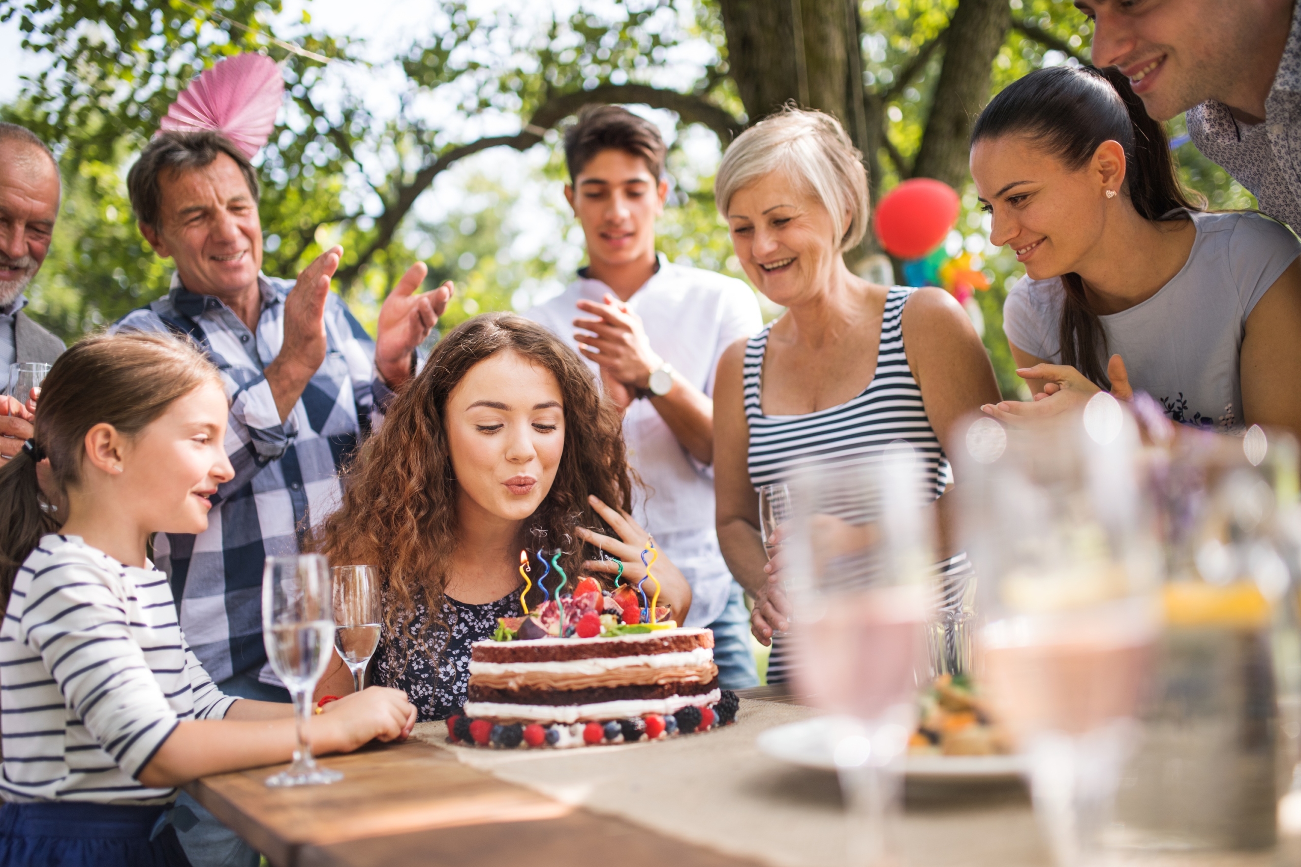 Teenage girl and her family celebrating her birthday