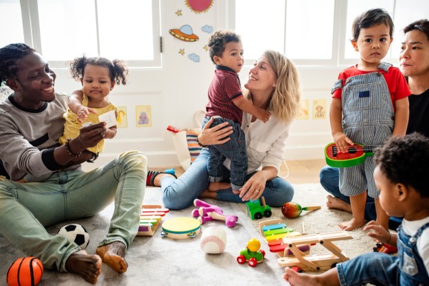 Toddlers having fun in a playgroup with parents