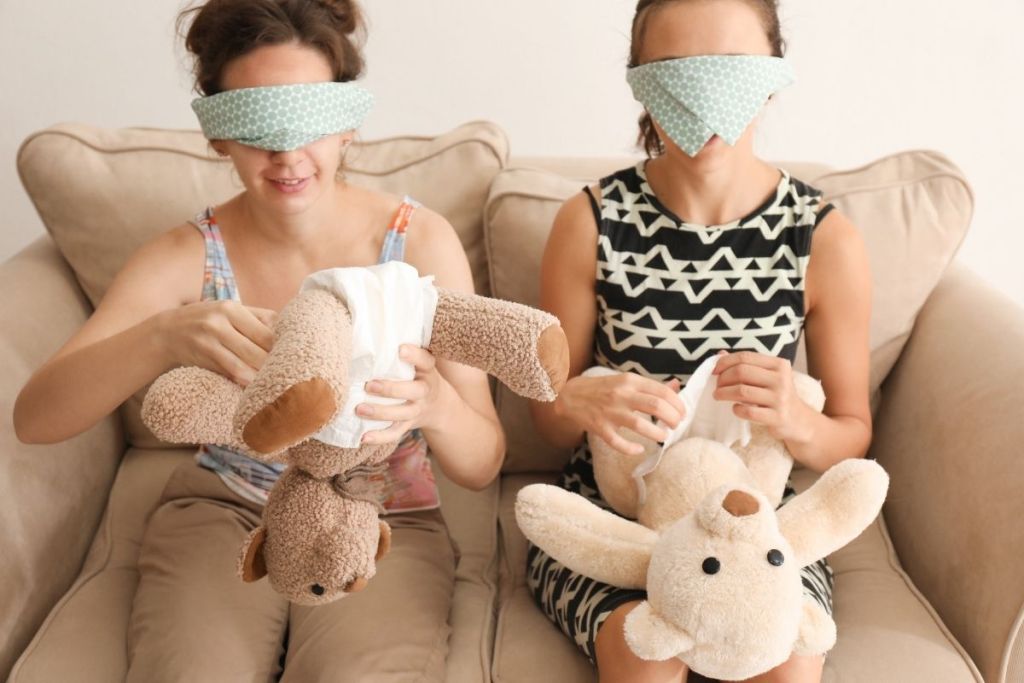 Two women playing a game at a baby shower