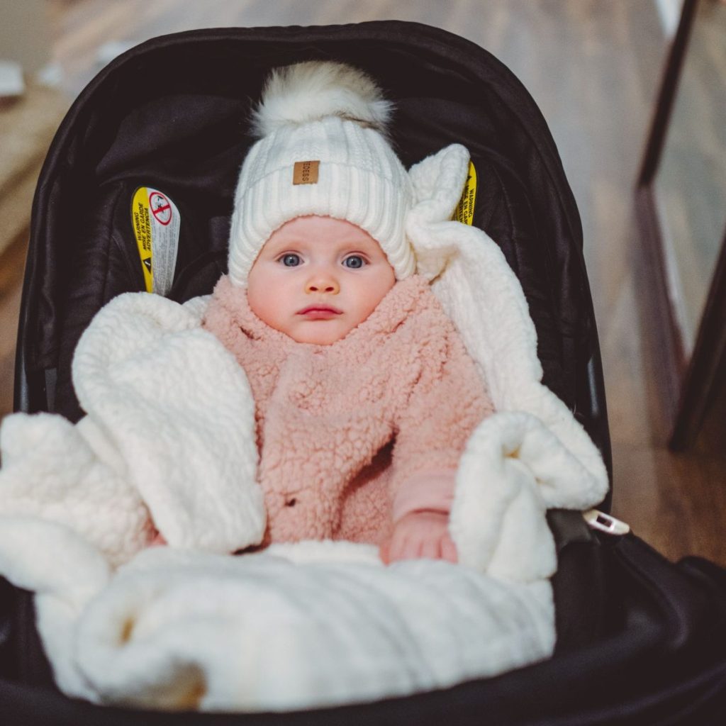 Baby in a seat bundled up for winter cold
