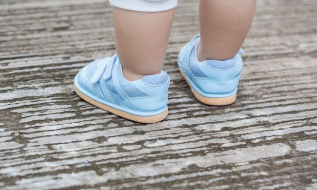 Child wearing baby shoes outside
