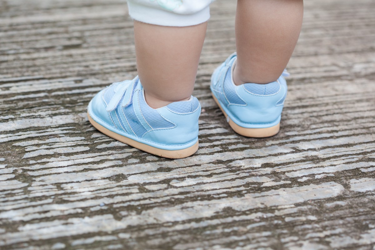 Child wearing baby shoes outside