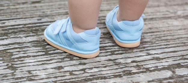 Child wearing baby shoes outside