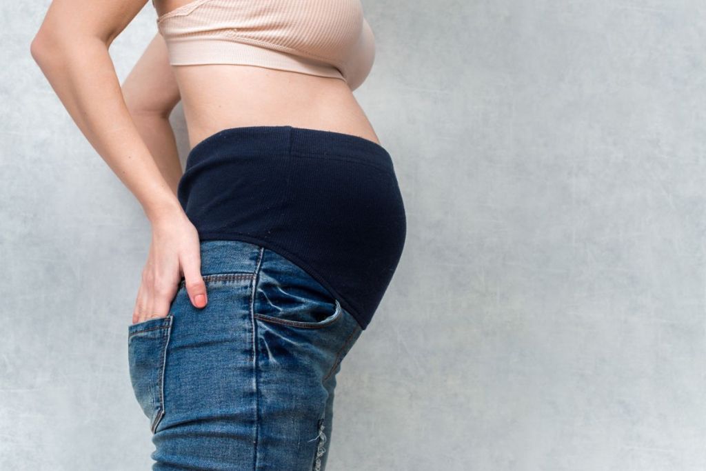 Woman in jeans with a belly band