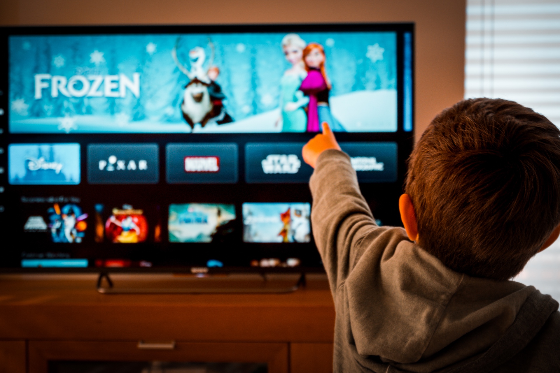 Boy watching Disney+ on TV