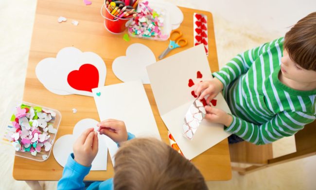 Little kids making Valentine's Day crafts