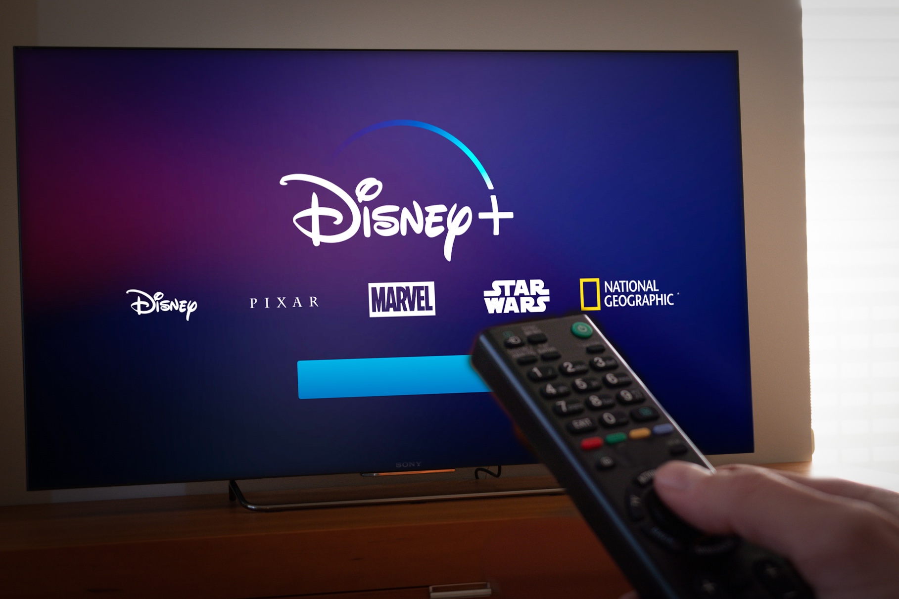 Disney+ being watched on TV with remote