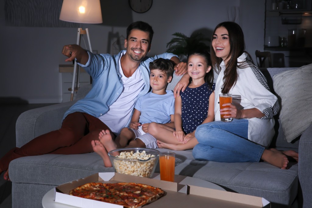 Family watching TV together on the couch