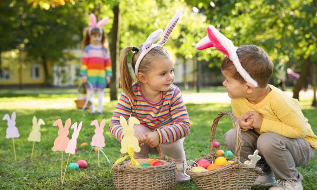 A boy and girl having fun during an Easter egg hunt