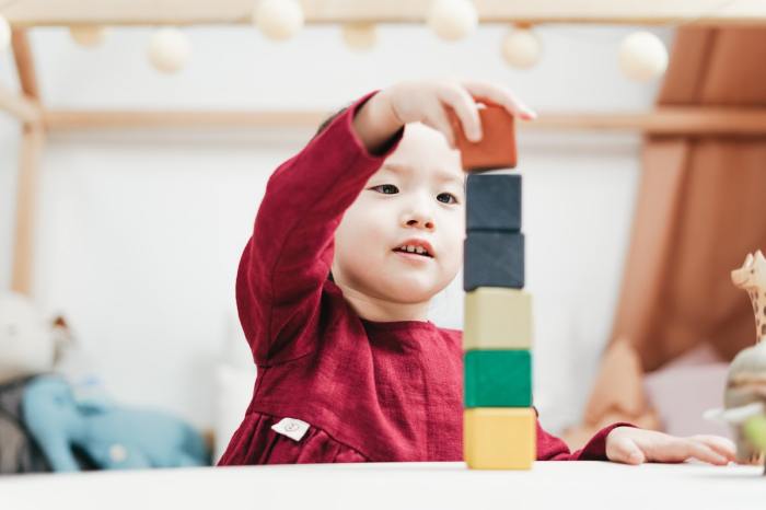 Toddler building with colored blocks