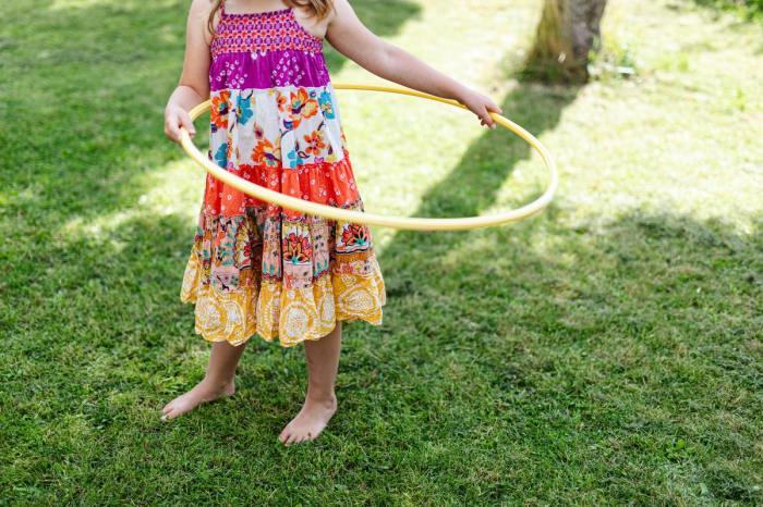 Girl playing with hula hoop in the backyard