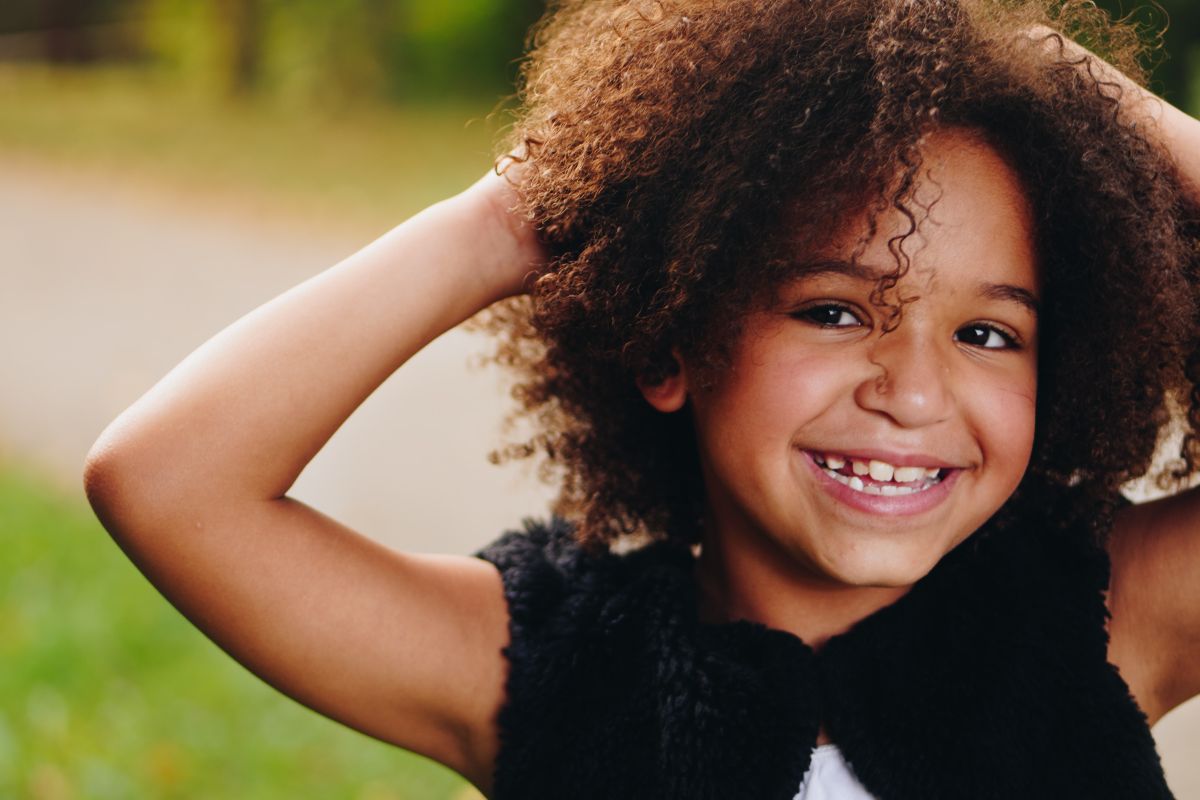 Smiling girl standing outside