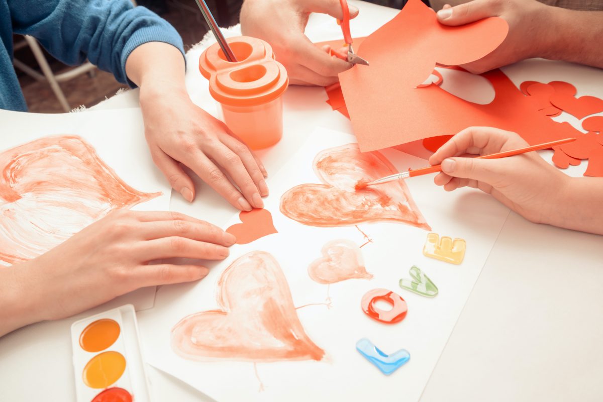 A family paints and creates Valentine's Day cards