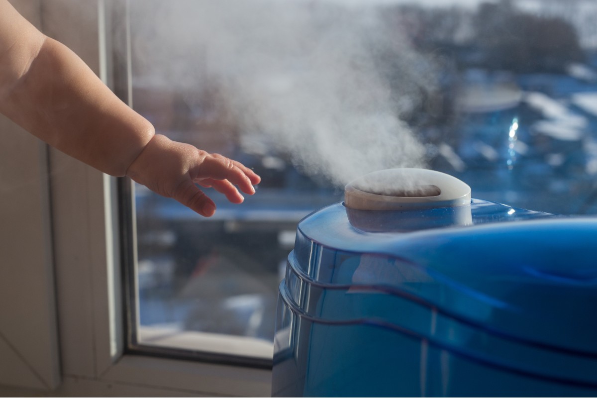 Infant reaching for a humidifier