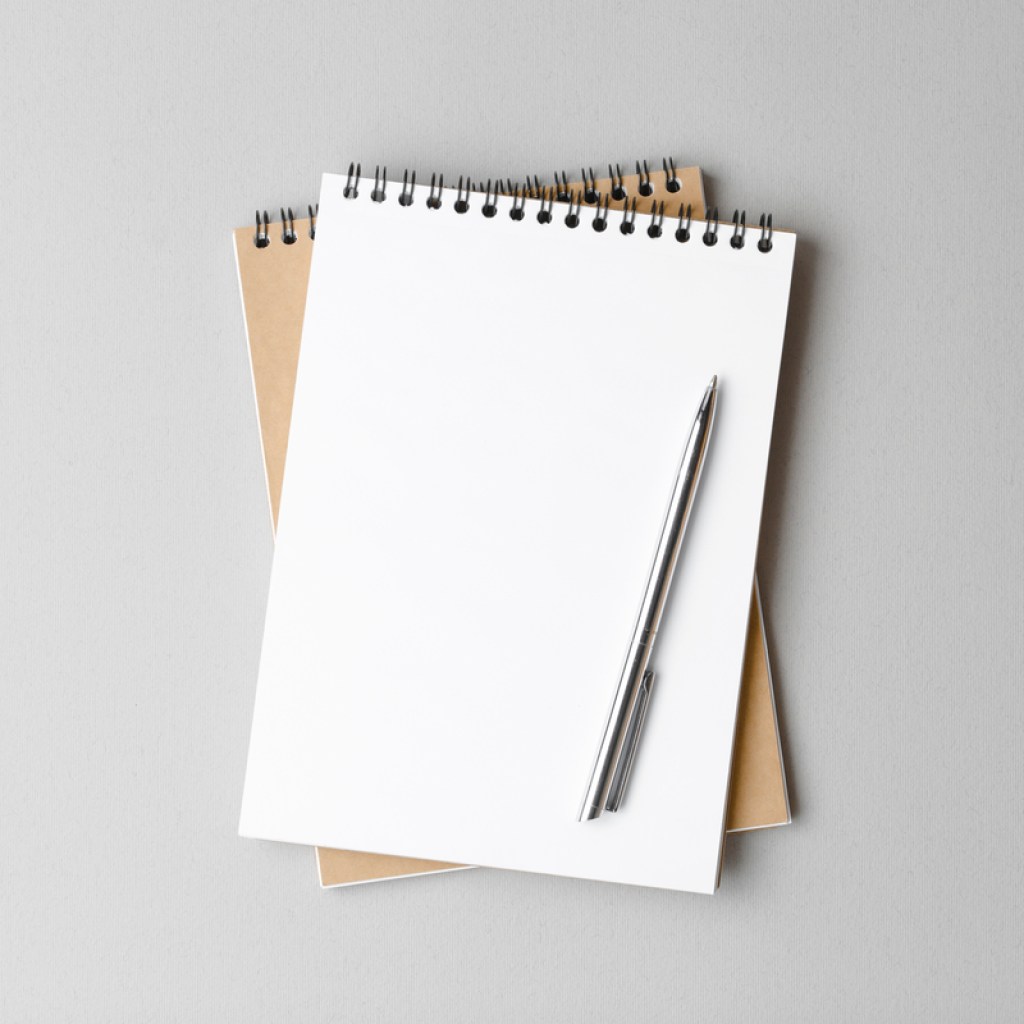 A blank notebook and a pen