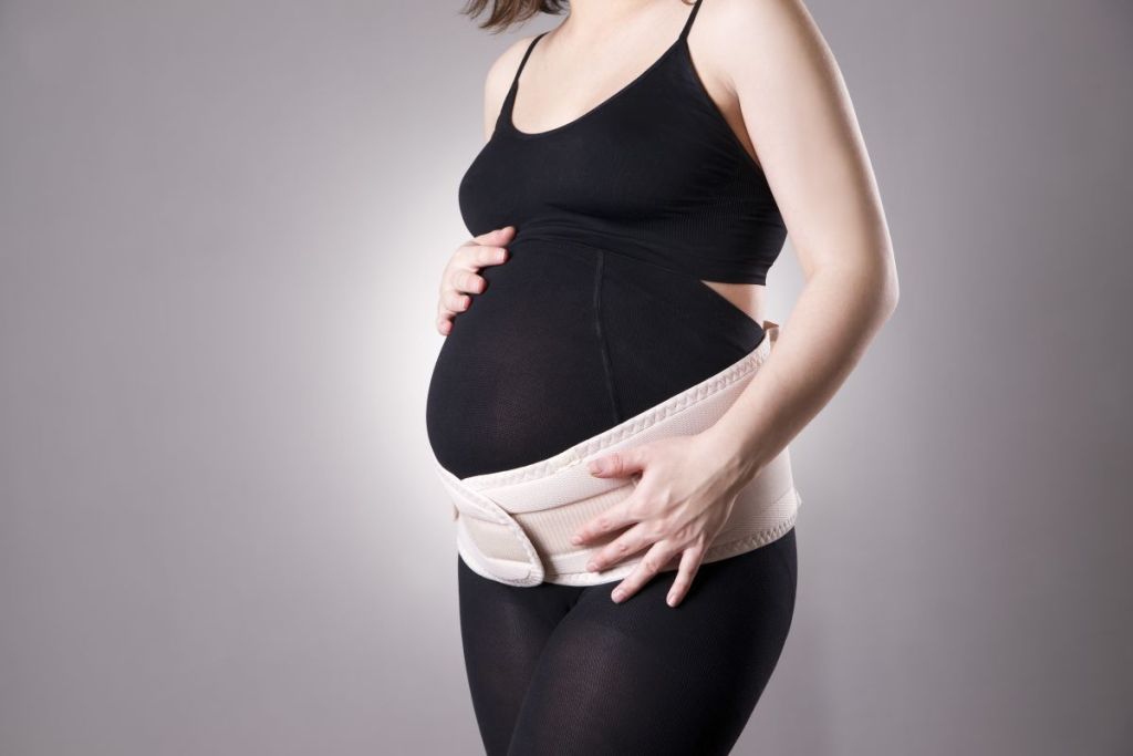Standing pregnant woman in belly band