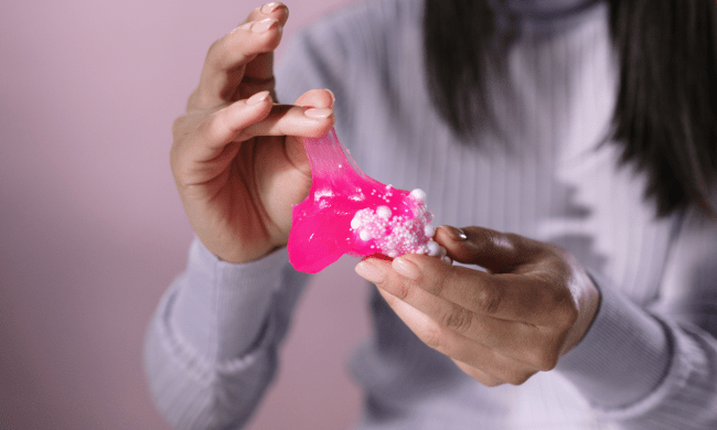 Woman with slime between fingers
