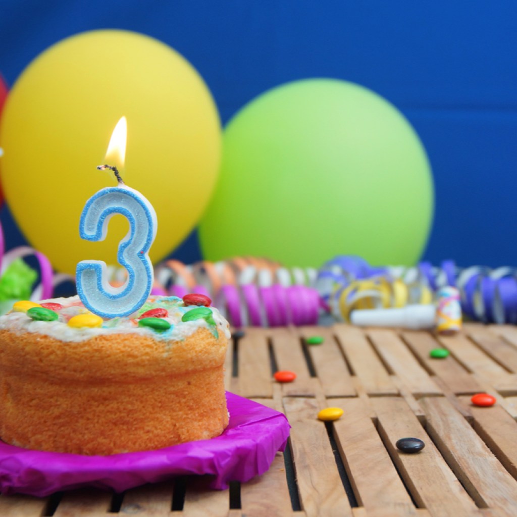 Birthday cake with a number 3 candle on it