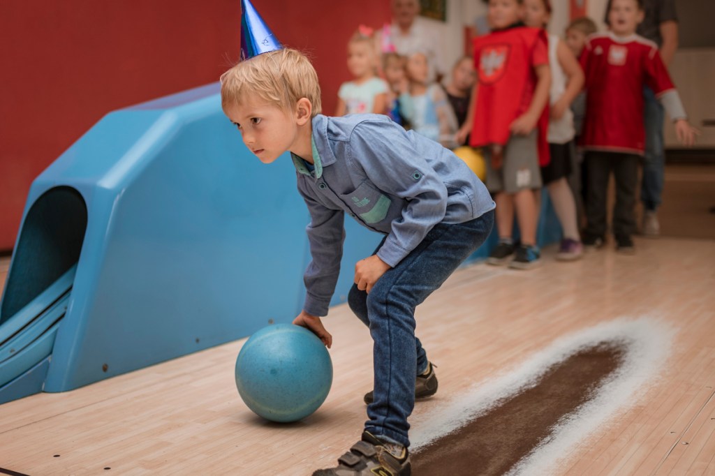 Boy with birthday hat at a bowling alley