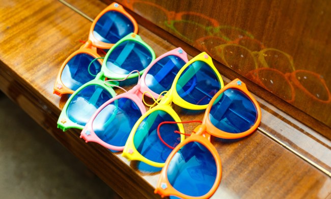 Children's sunglasses laid out in multiple colors