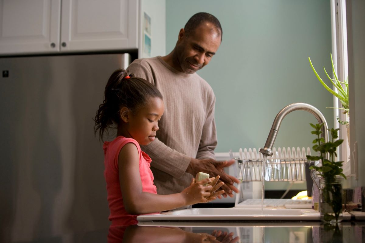 Dad and daughter washing hands