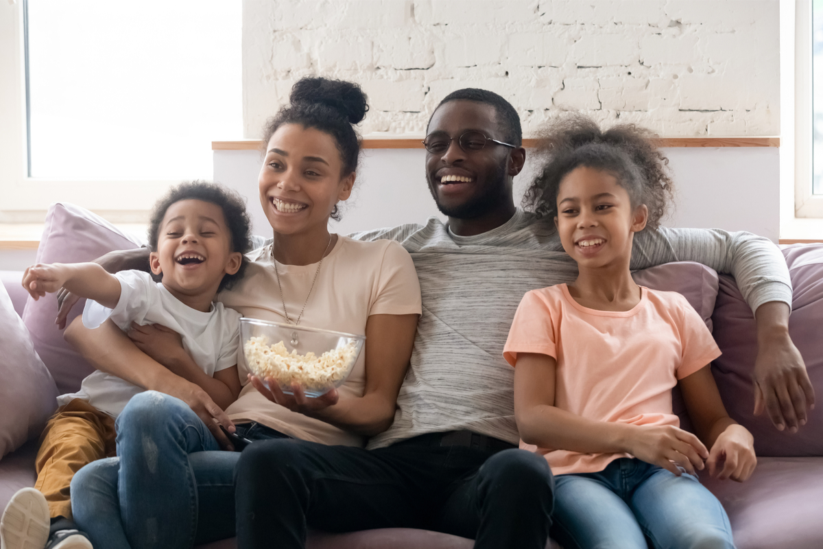 Family on couch watching TV