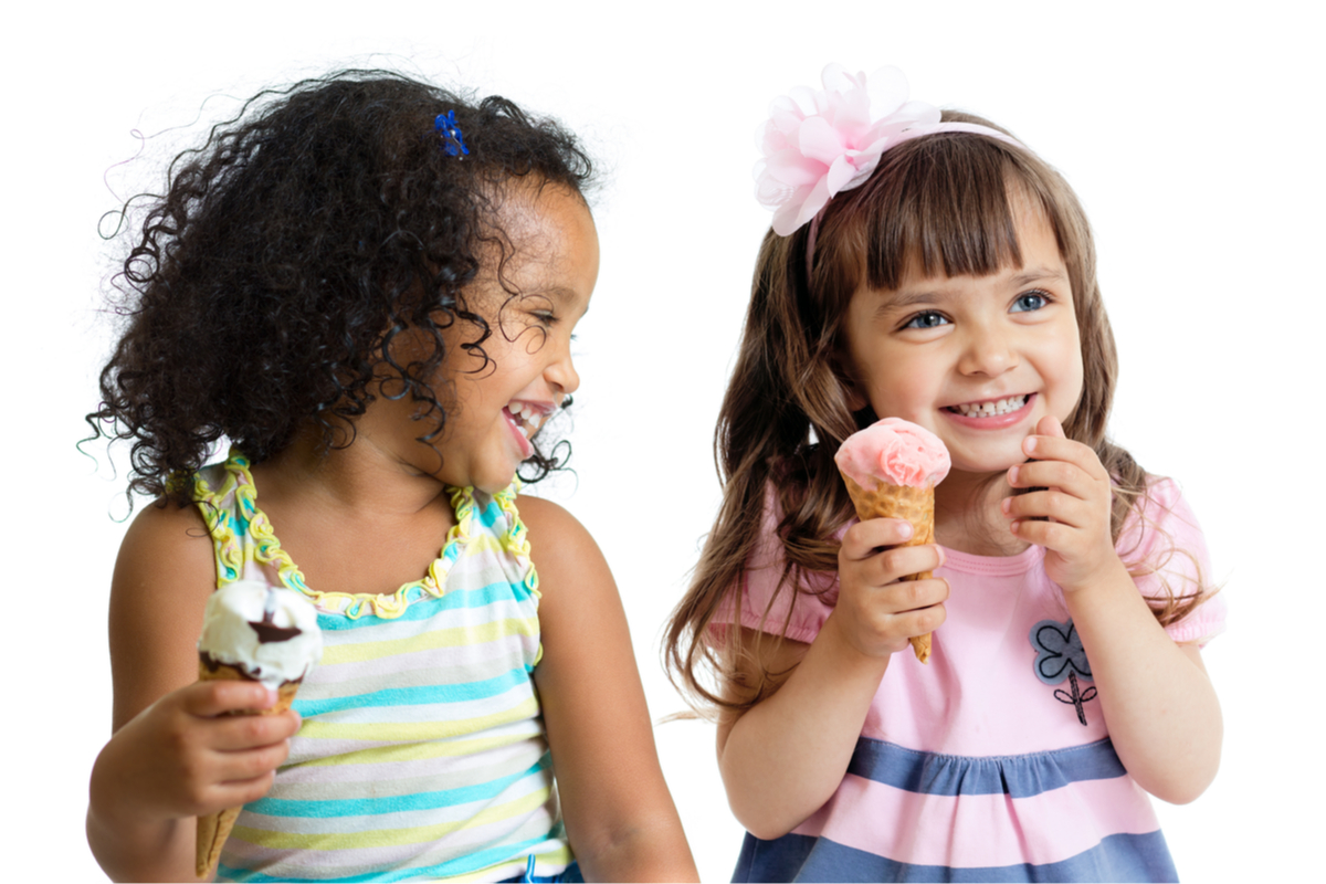 Two happy girls holding ice cream cones