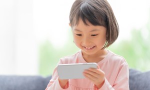 Little girl having fun playing on a smartphone