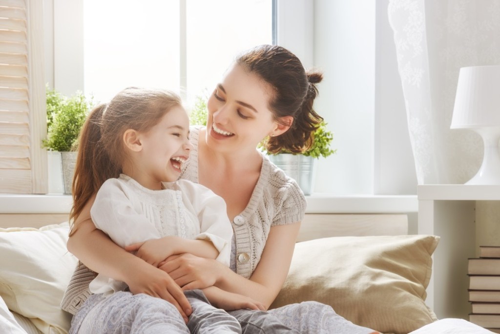 Mother laughing with her young daughter