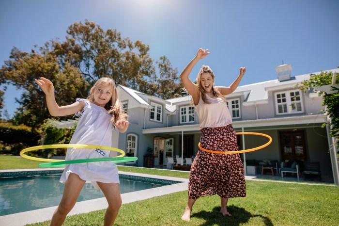 A mom and daughter having fun with hula hoops