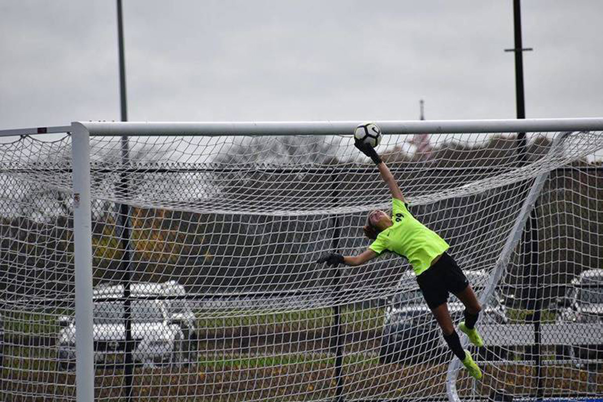 Julia Masucci making a save in a high school soccer game