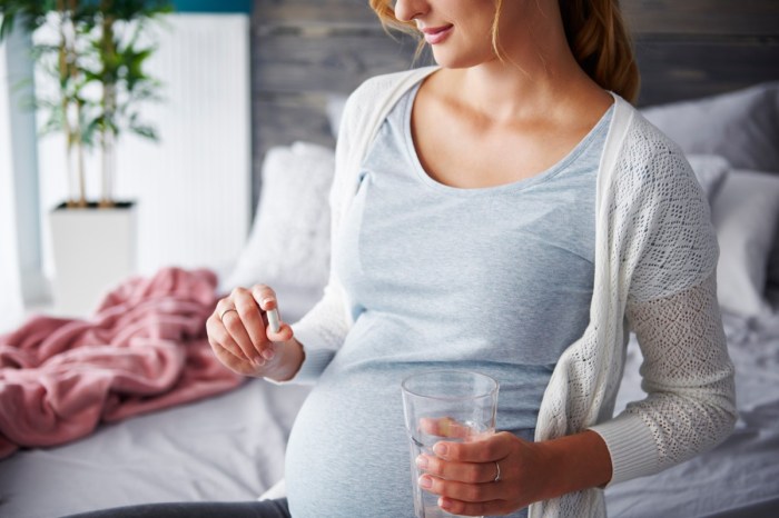 Woman holding prenatal vitamins