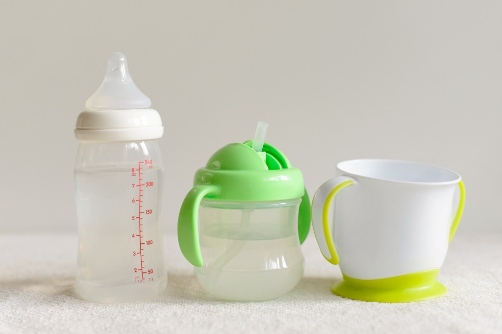 A baby bottle, sippy cup, and cup