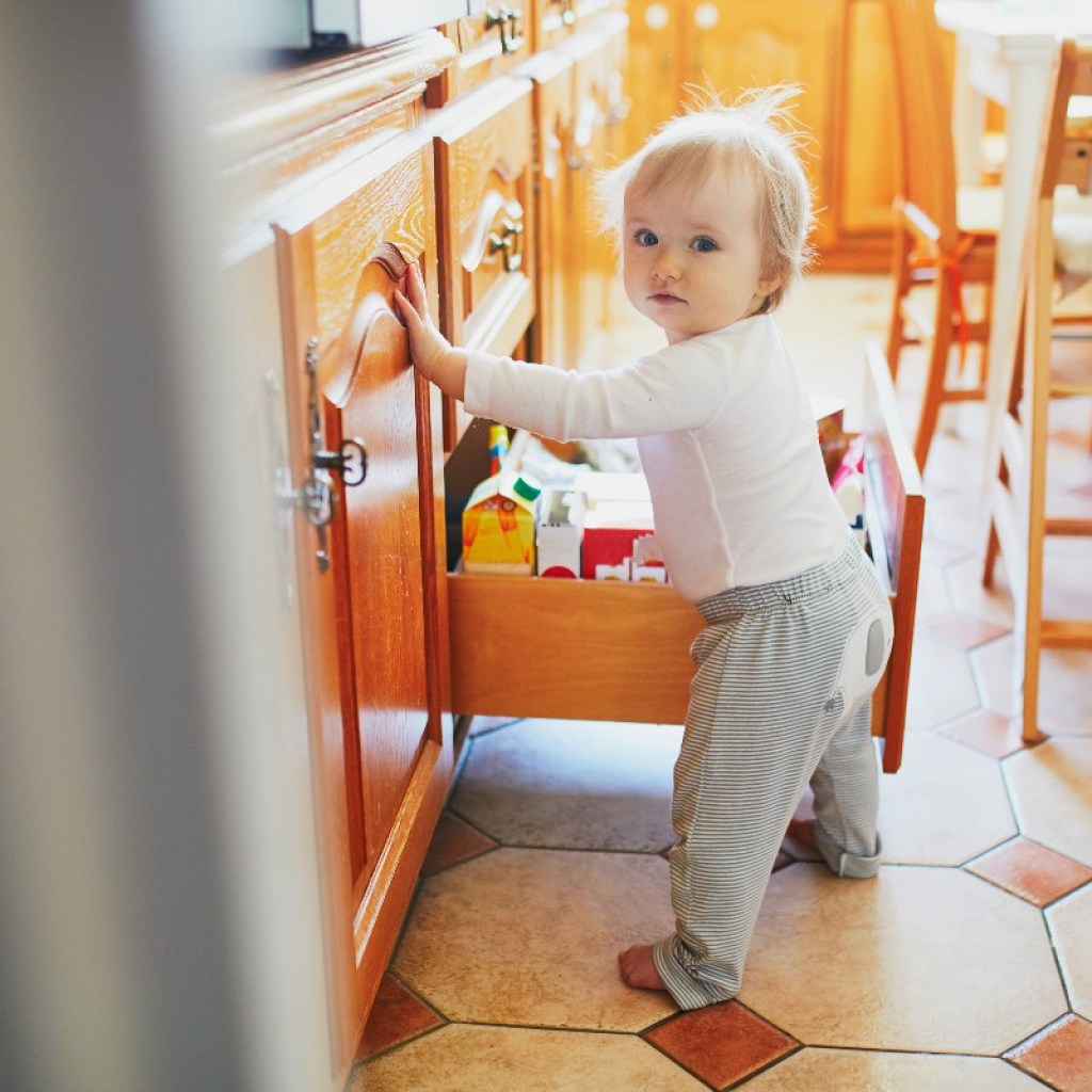 baby going through drawers in kitchen