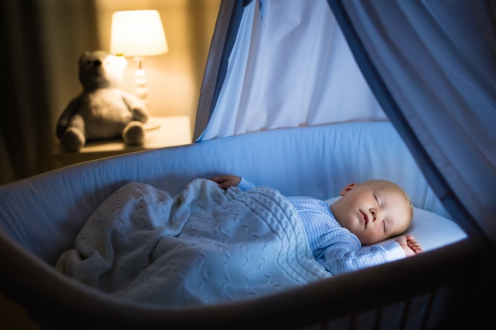 A baby sleeping in a bassinet