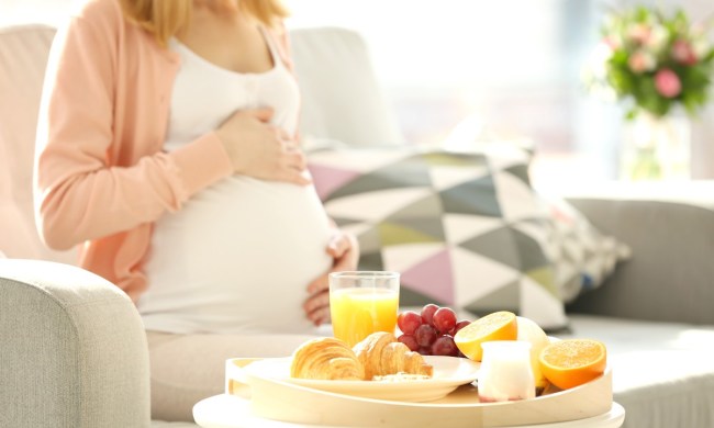 Pregnant woman with fruit and orange juice.