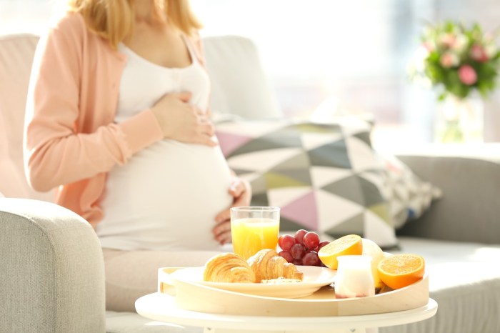 Pregnant woman with fruit and cheese plate