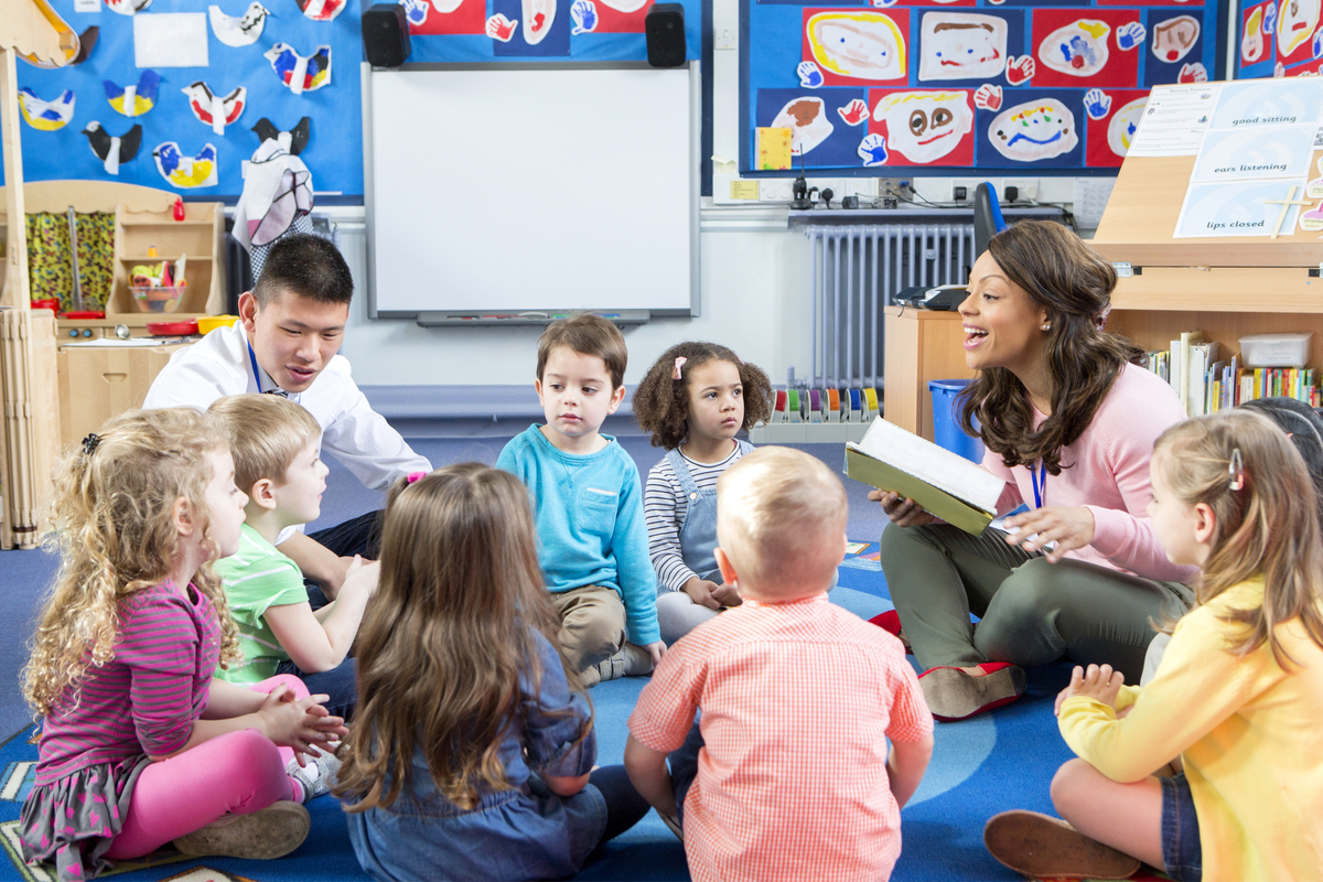 Circle time in a preschool classroom with children and teachers sharing a story