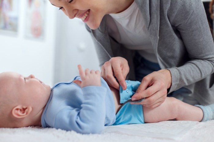 A mom making a cloth diaper change on a baby