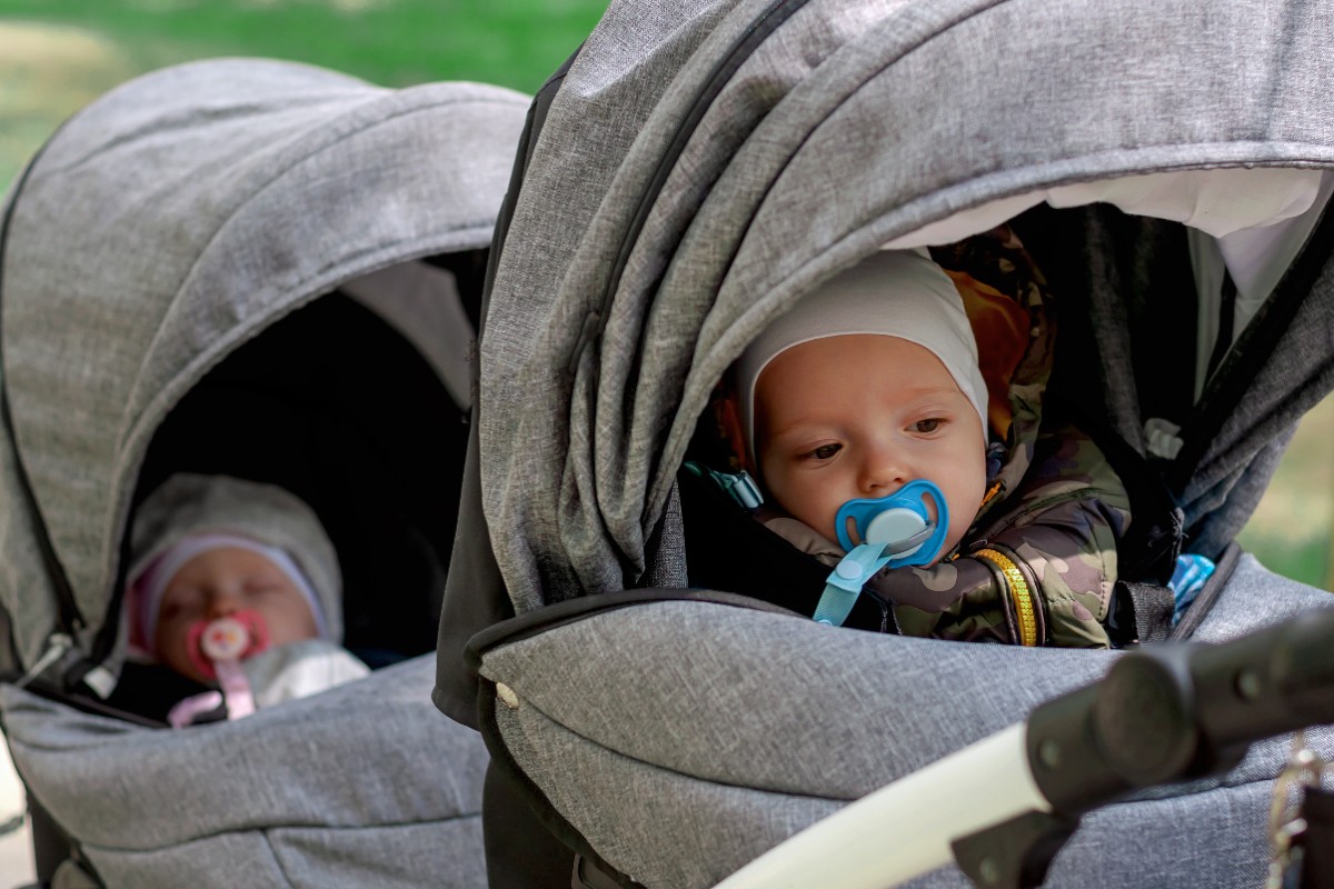 Two babies in a double stroller.