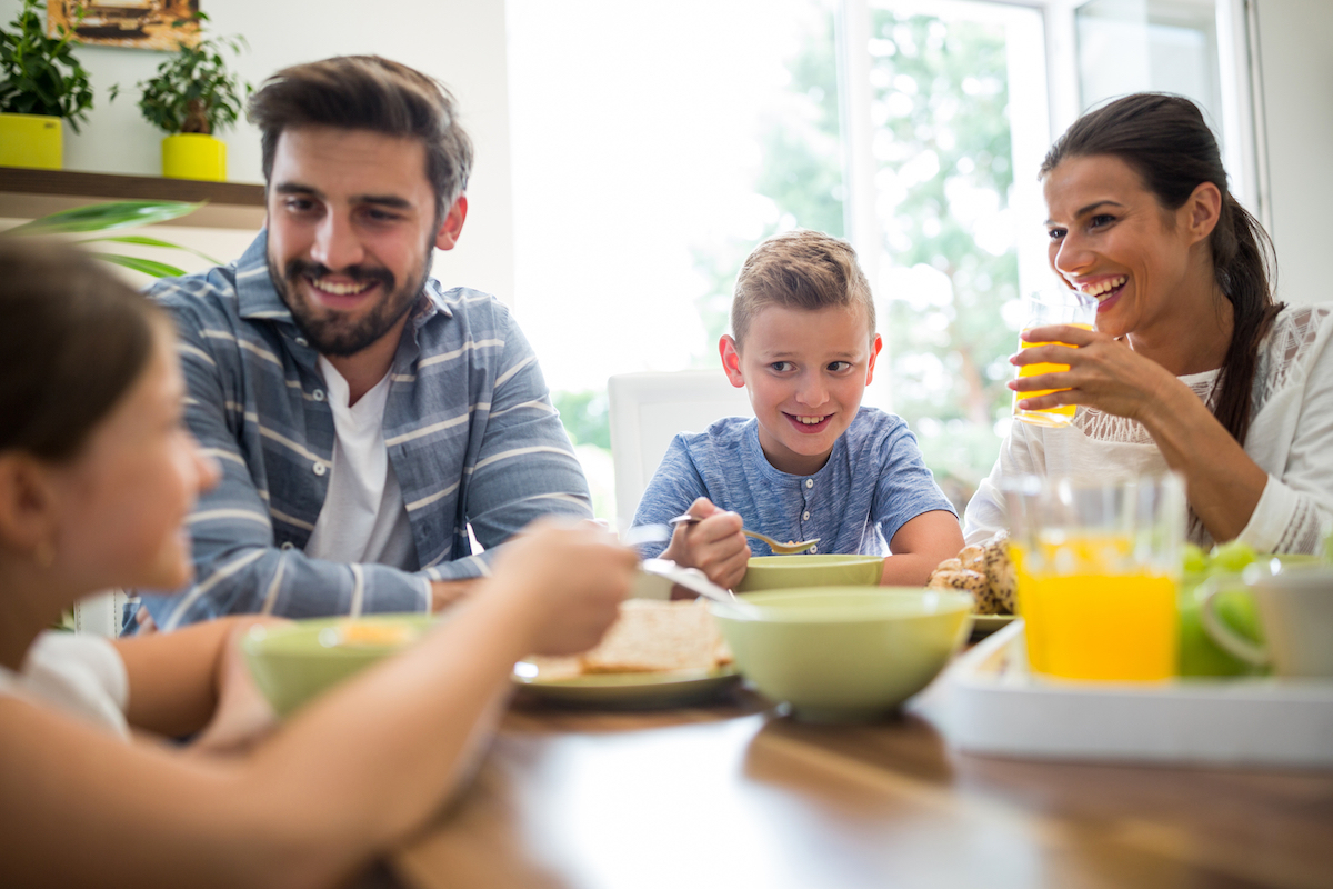 A happy family eating breakfast together